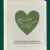 Close-up of a white greeting card on top of a cream-colored envelope, all on a forest green background. Card features a drawn image of a gravy boat in a green heart with text that reads "its been said that marriage is the union of two halves of the same soul"