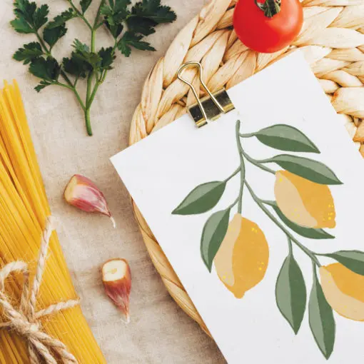 Photo of card next to some food. The card shows a picture of lemons on the vine.