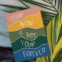 Photo of card on leaves. The card reads 