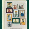 Close-up of a white greeting card on top of a cream-colored envelope, all on a forest green background. Card features drawings of essential workers wearing masks in picture frames. Text underneath reads "i knew you were essential before the pandemic"