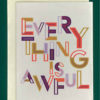 Close-up of a white greeting card on top of a cream-colored envelope, all on a forest green background. The outside of card says in purple, red and golden colorful designed letters, "Everything is awful."